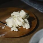 Close-Up Shot of a Creamy Butter on a Wooden Plate